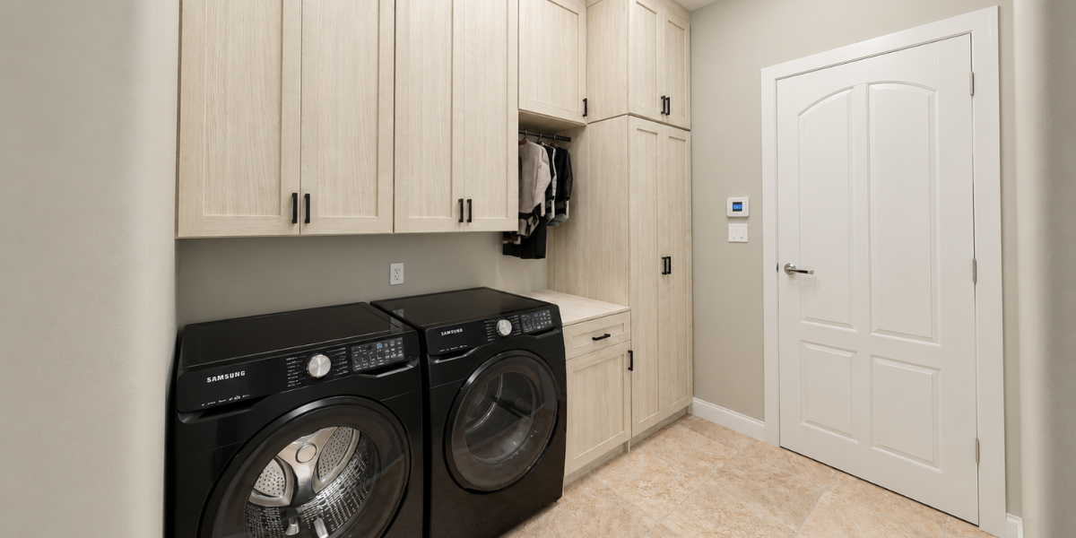 Custom laundry room with storage designed by SpaceManager Closets