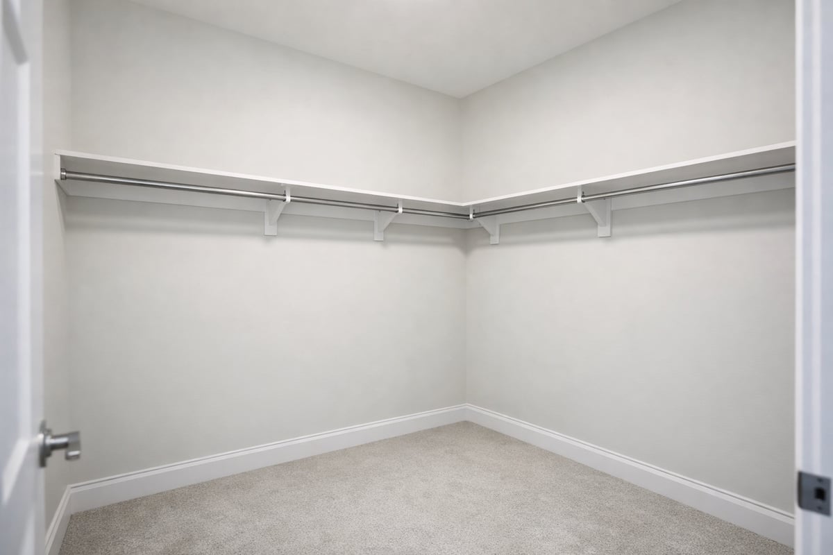 Image of an average builder-grade closet with a single shelf and hanging rod layout.
