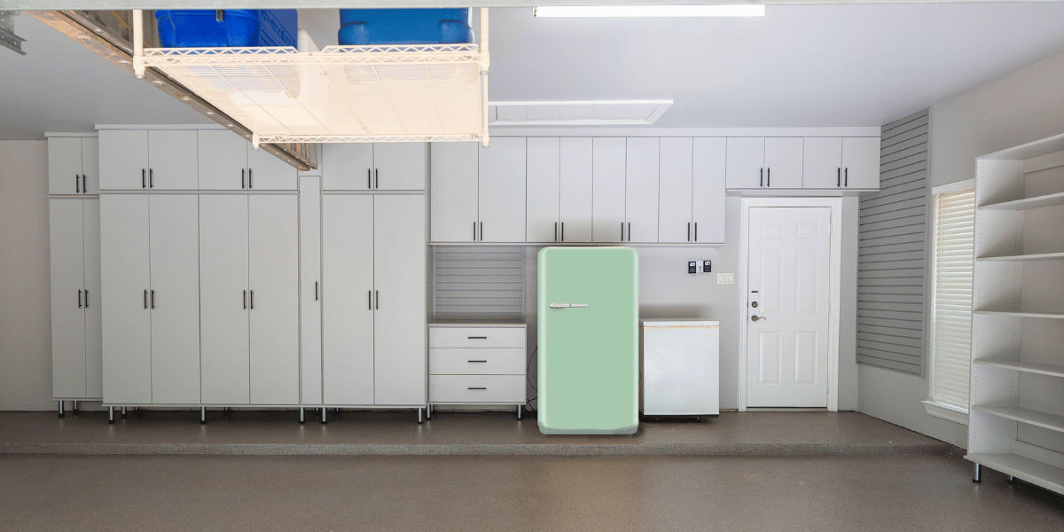 Custom garage cabinet storage with slatwall and overhead storage rack designed by SpaceManager Closets 