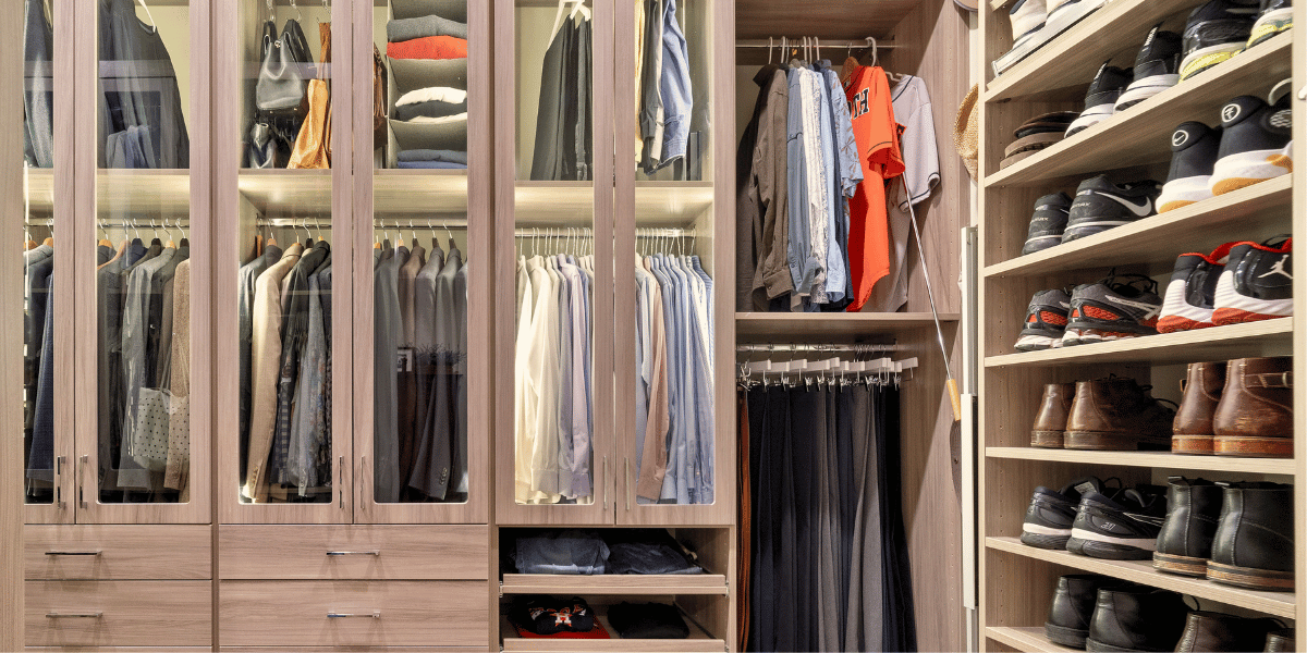 Modern custom walk-in closet in a Houston home featuring warm wood grain finishes and integrated LED lighting — 2026 design trend