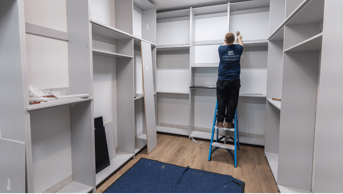 Photo of a SpaceManager Closets Installation team member installing a custom closet system in Houston, Tx.