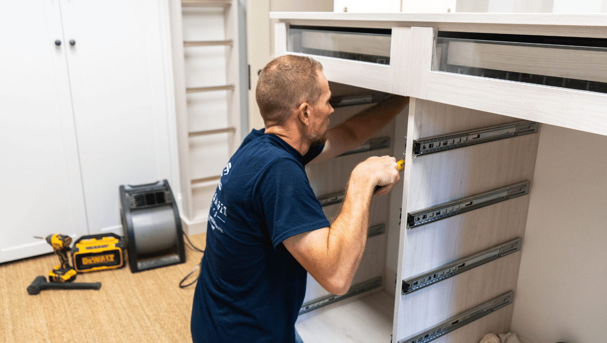 Photo of a SpaceManager Closets Installation team member installing a custom closet system in Houston, Tx.