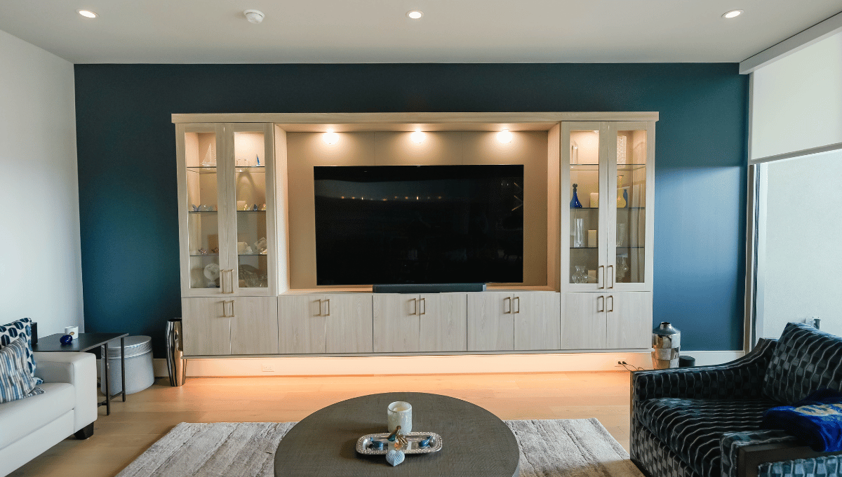 Built-in entertainment center with glass display cabinets designed by SpaceManager Closets