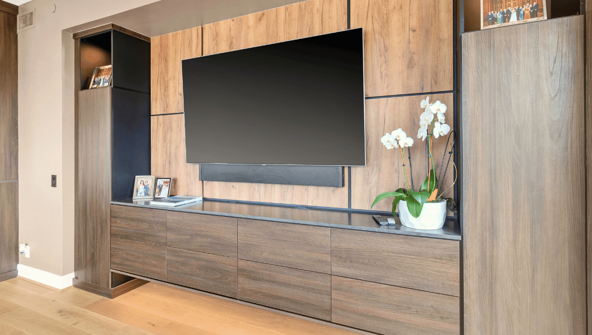 Custom built-in entertainment center with storage in dark wood designed by SpaceManager Closets