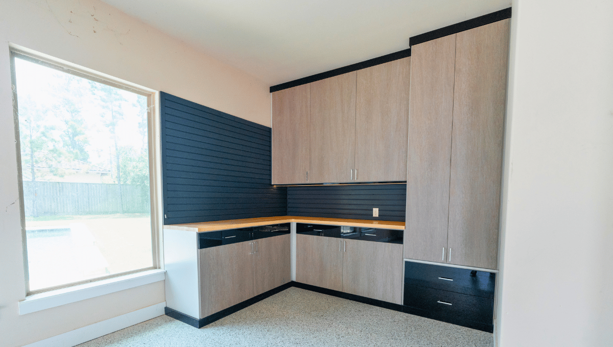 Custom garage cabinets with slatwall storage and countertop workspace designed by SpaceManager Closets