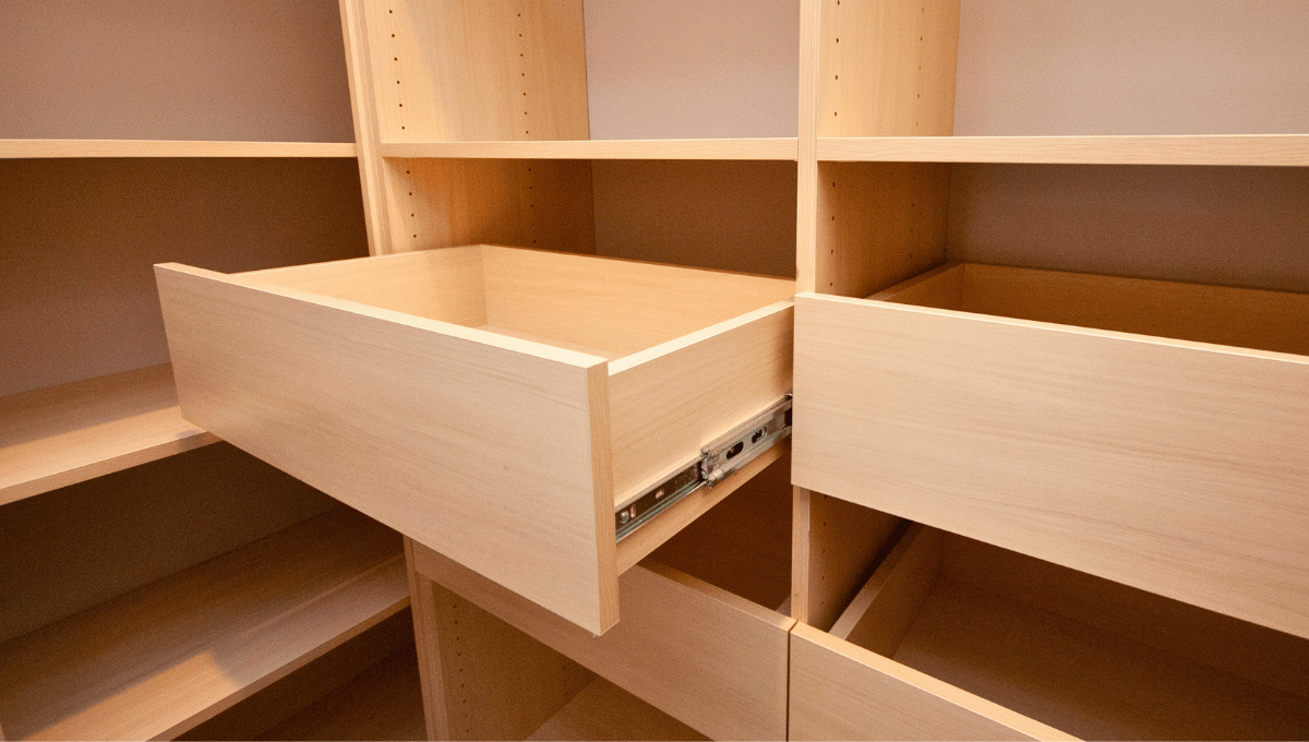 Custom pantry with pull-out drawers in light wood