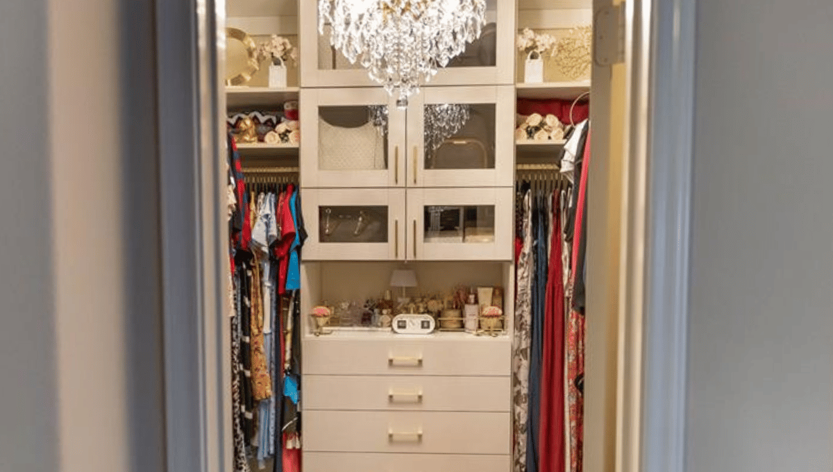 Image of a custom closet featuring gold accessories and white cabinets, designed and installed by SpaceManager Closets in Houston, Tx.