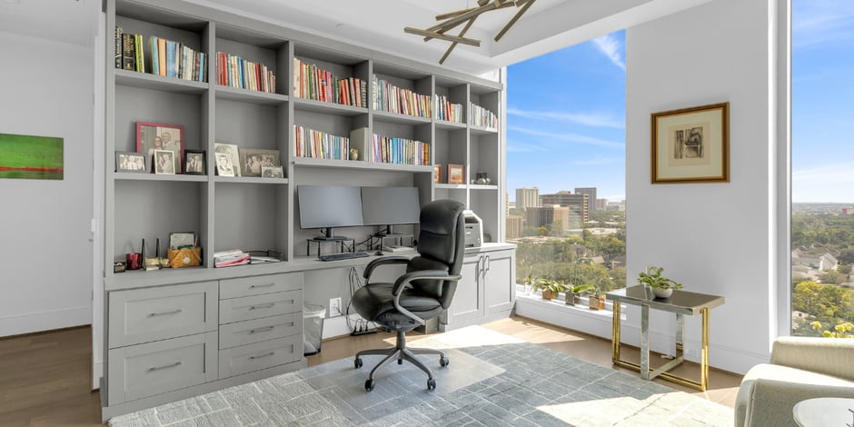 Small bedroom office conversion built-in desk, shelving, and storage designed by SpaceManager Closets