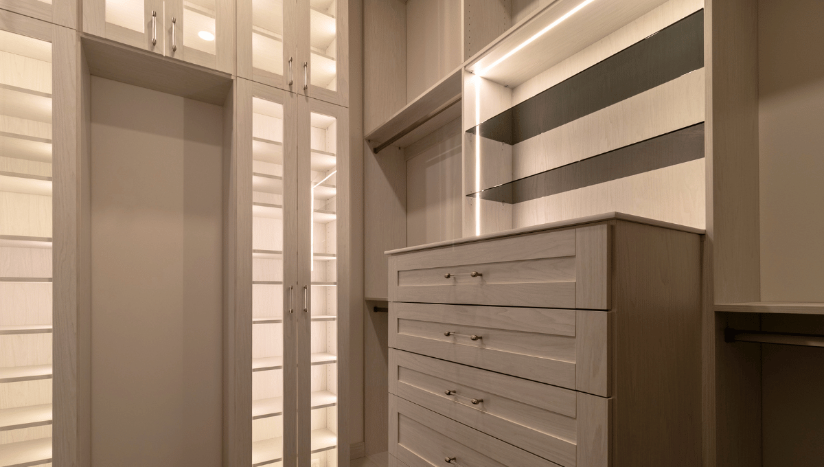 Custom closet with integrated recessed and trim LED lighting under shelves 