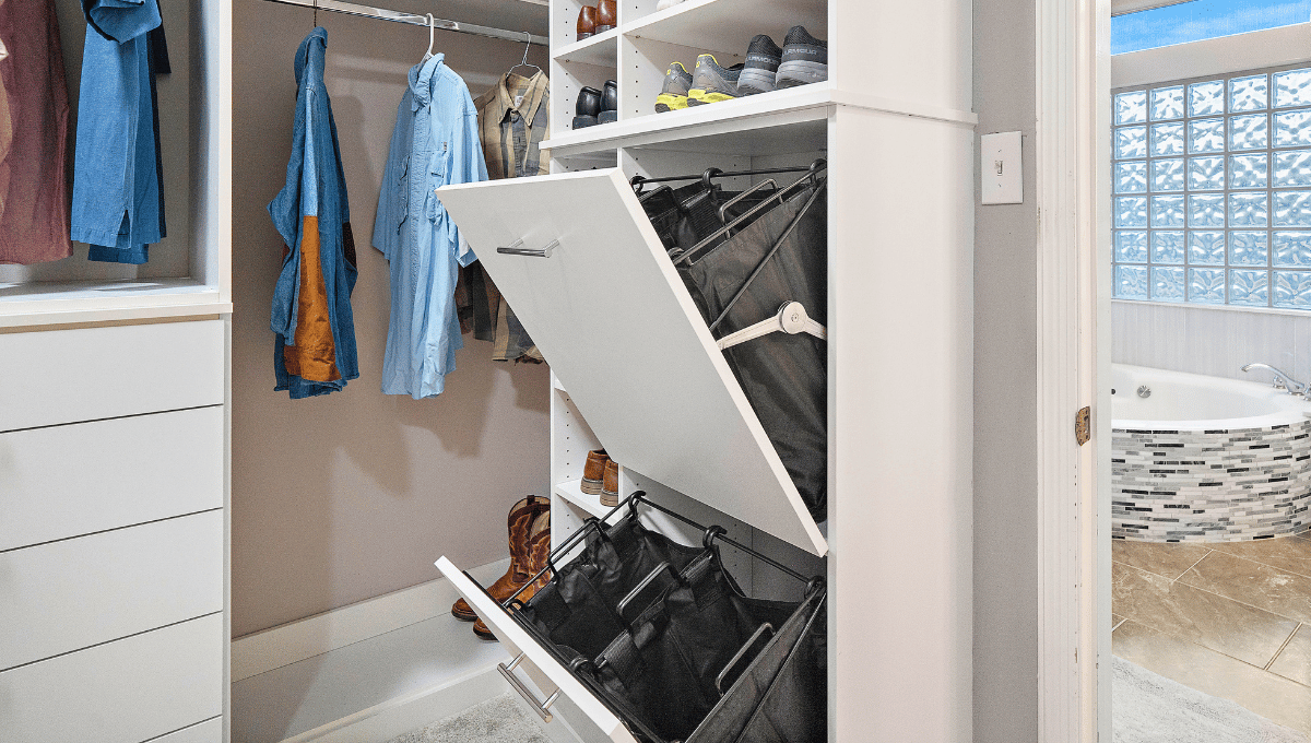 Photo of a custom closet with double built-in laundry hampers.