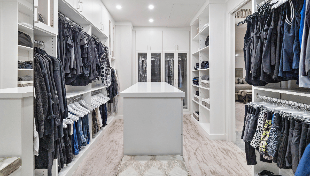 Photo of a luxury custom closet with an island designed in Houston, Tx.